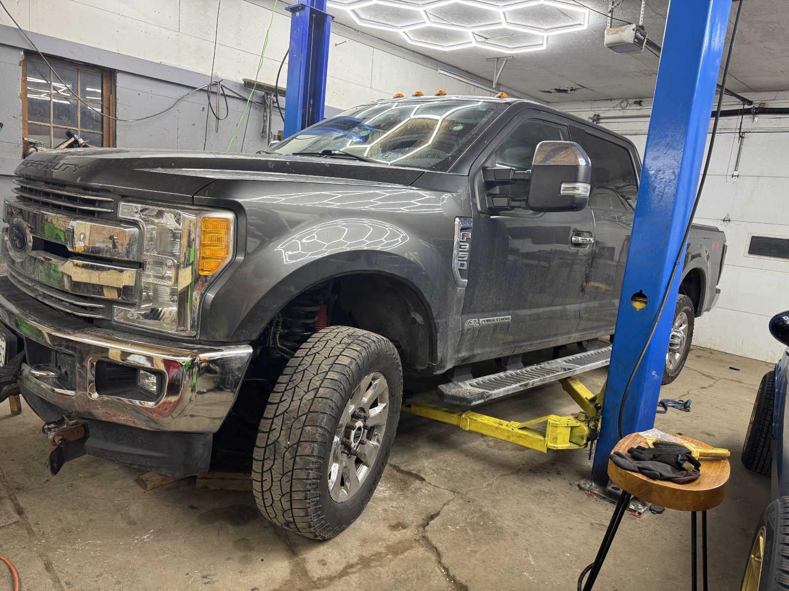 Truck up on the lift inside our Pingree Grove shop
